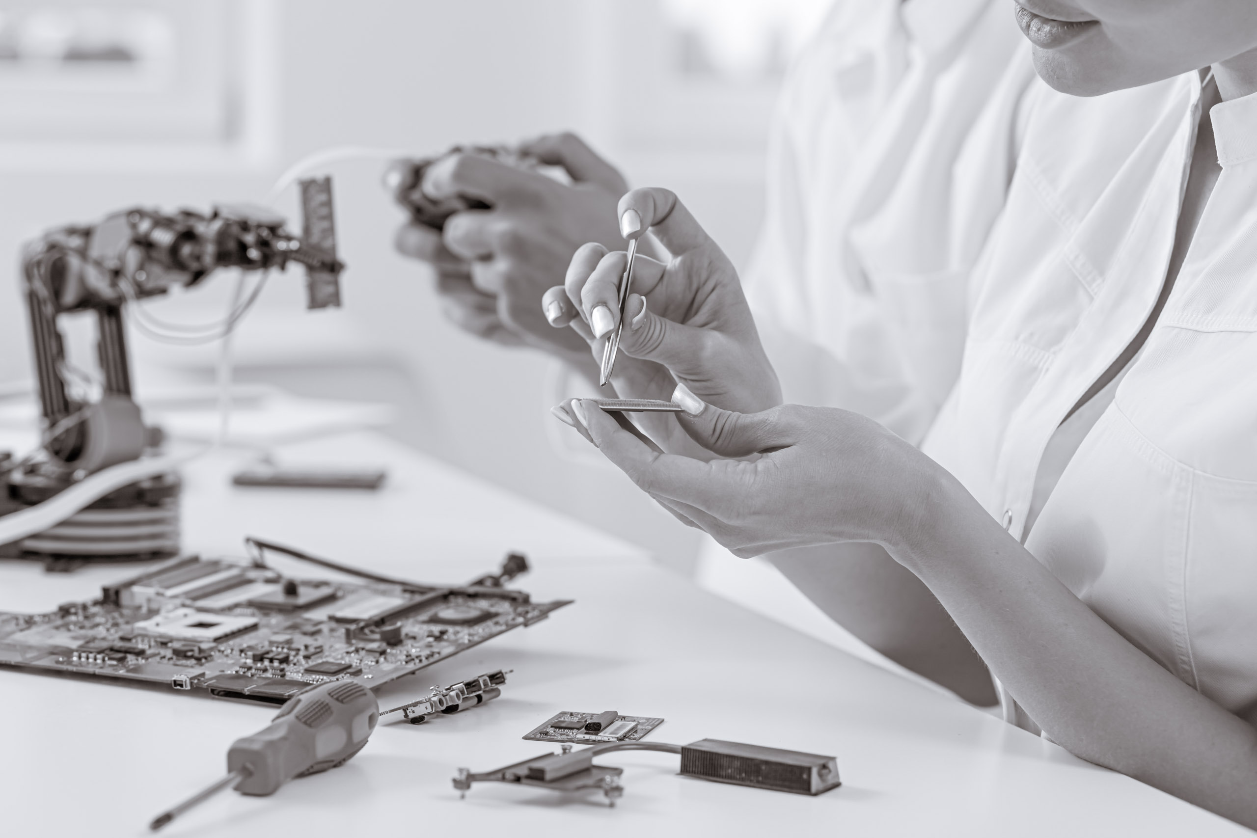 Engineers assembling robotic hardware at a laboratory bench