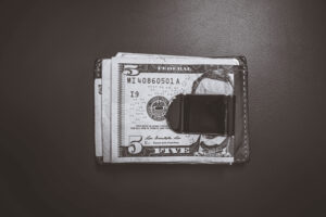 A money clip holding folded banknotes